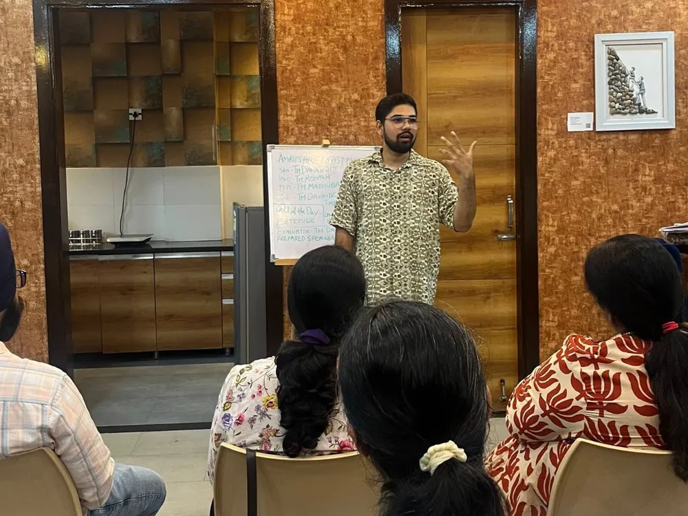 A member speaking to a seated audience