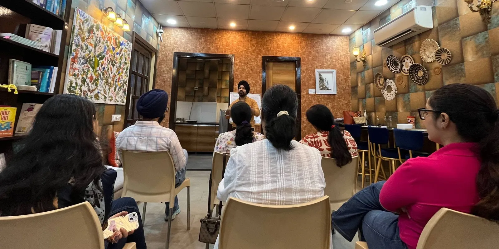 Members seated and listening to a speaker at a meeting