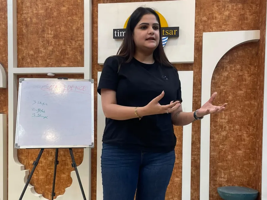 A member speaking beside a whiteboard that says Confidence